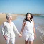 women walking along the beach